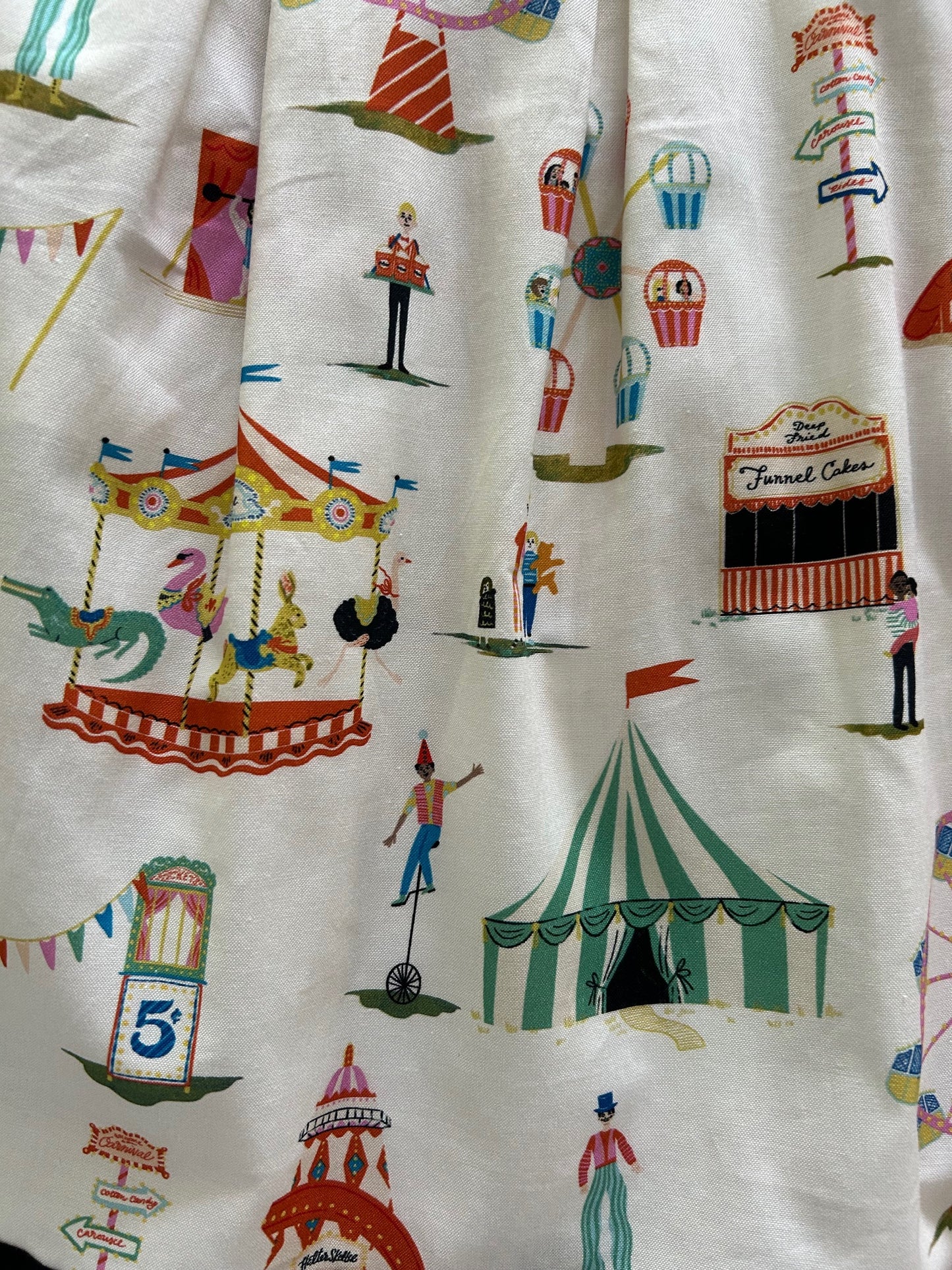 close up of the print showing different carnival rides