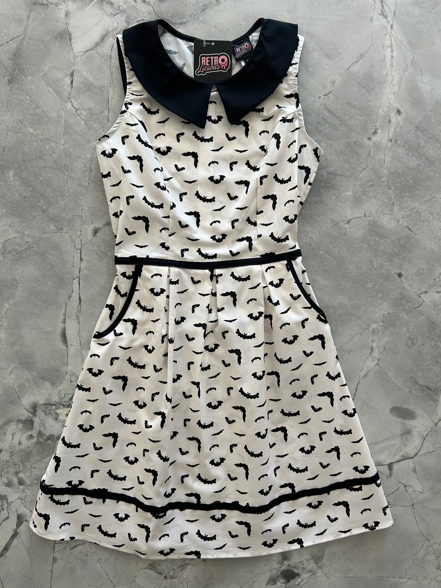 flatlay of bats collared dress