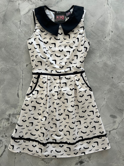 flatlay of bats collared dress