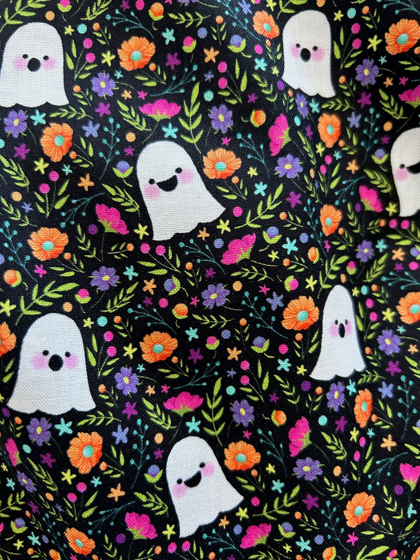 close up of fabric showing floral background and all over ghosts