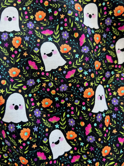 close up of fabric showing floral background and all over ghosts