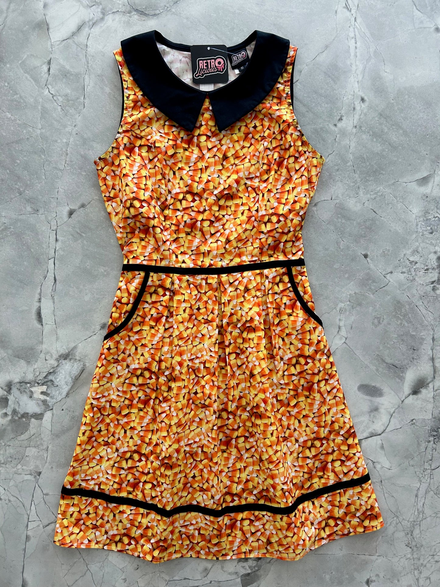 flat lay of candy corn collared dress