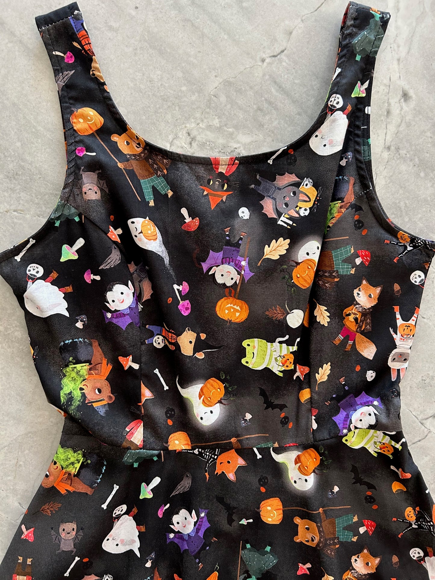 close up of bodice of ghoulish skater dress showing cute animals dressed in halloween costumes