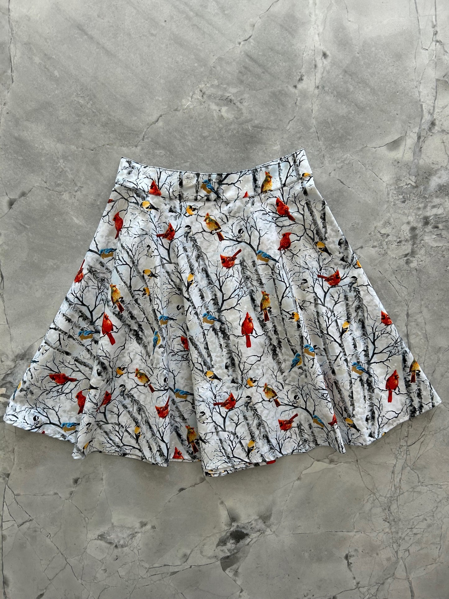 flatlay of birds on branches skater skirt