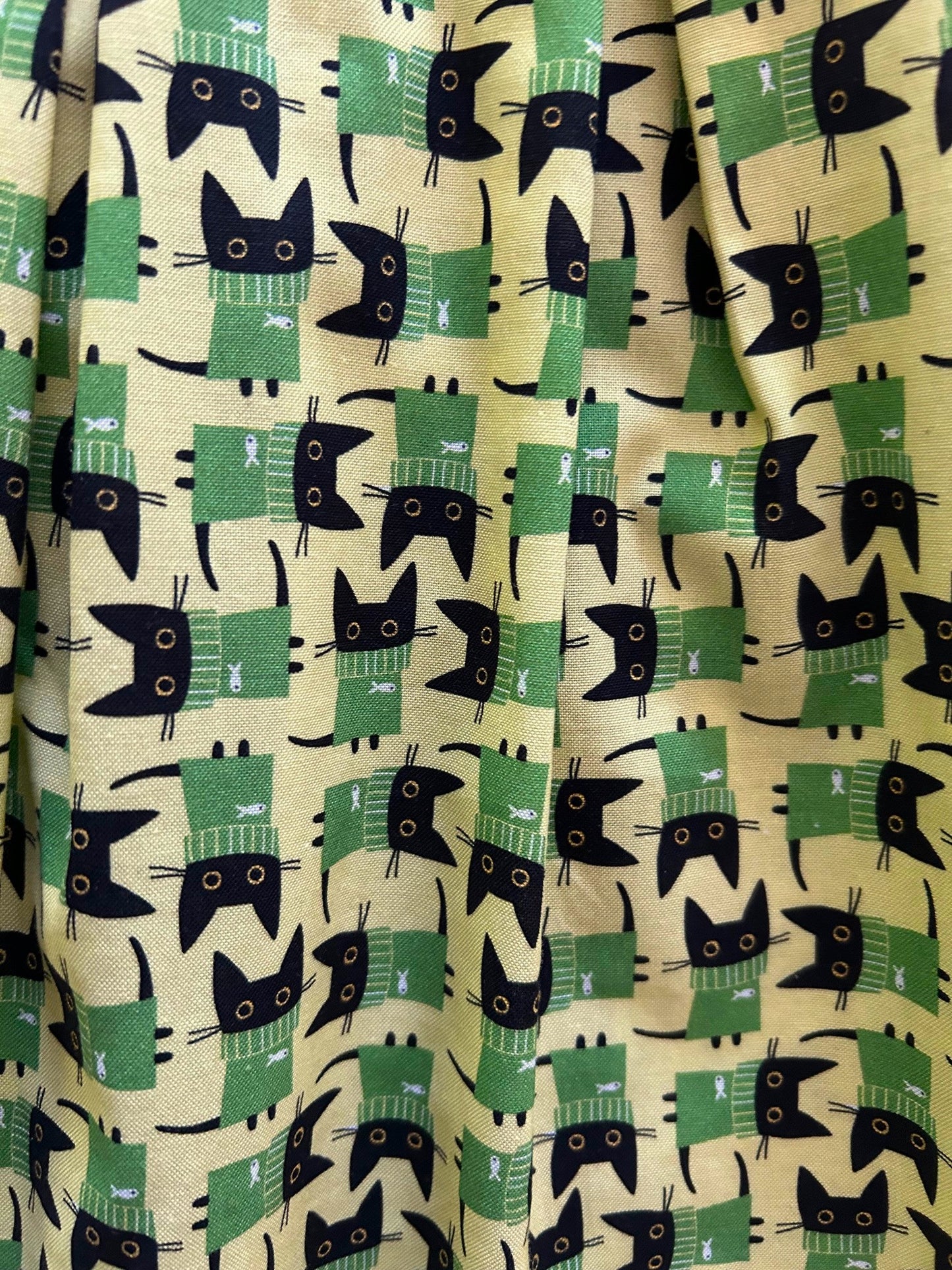 close up of fabric showing the cats in sweaters