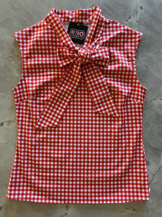 flatlay of red gingham bow top