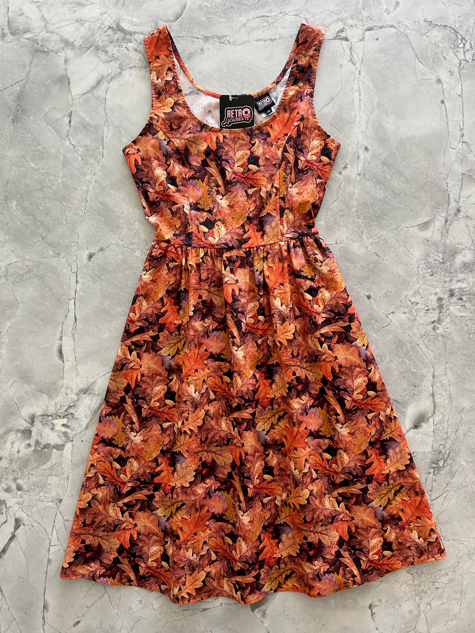 flatlay of leaves fit and flare dress