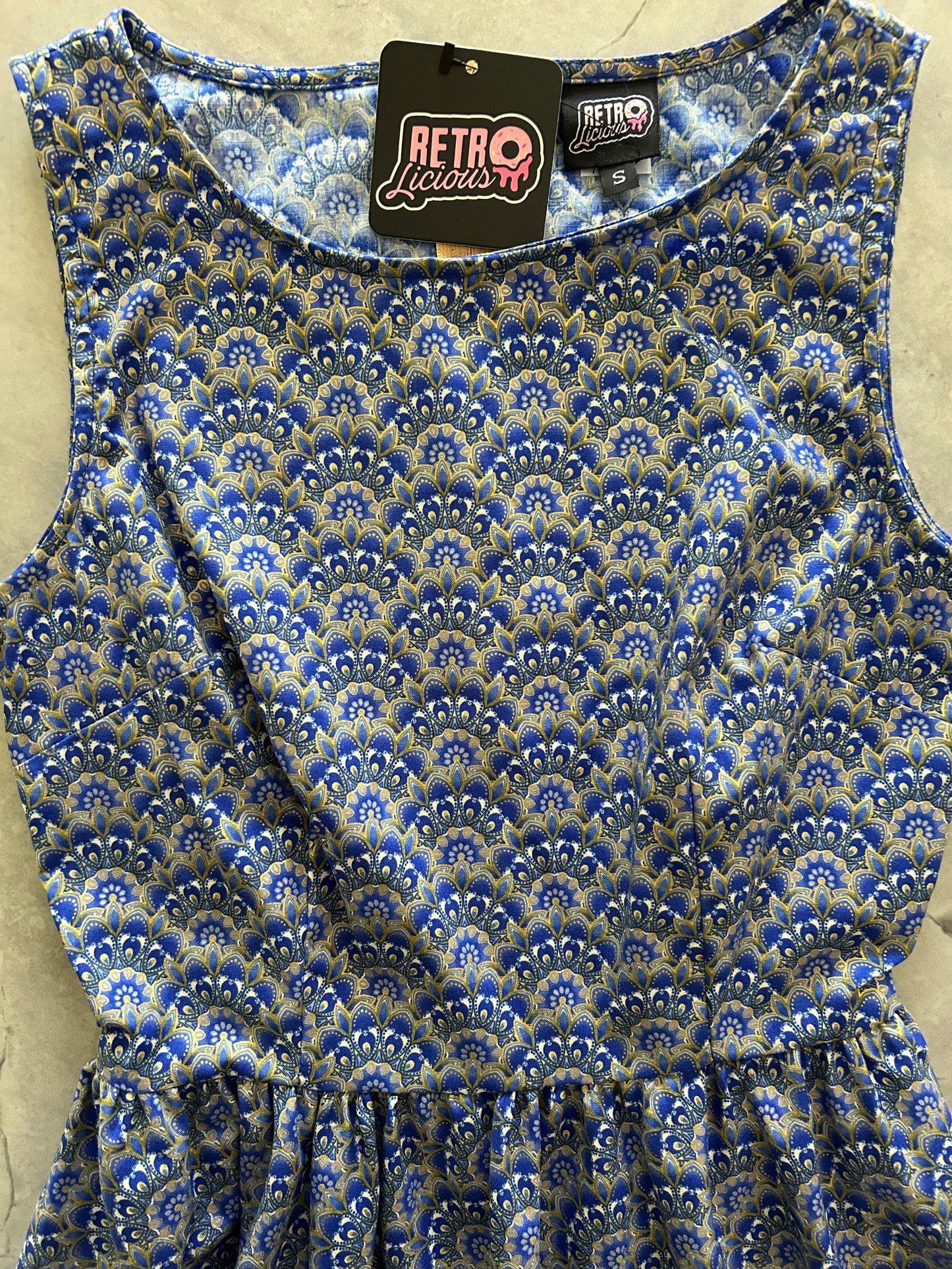 flatlay of the bodice showing blue and gold fan shaped print of florentine vintage dress