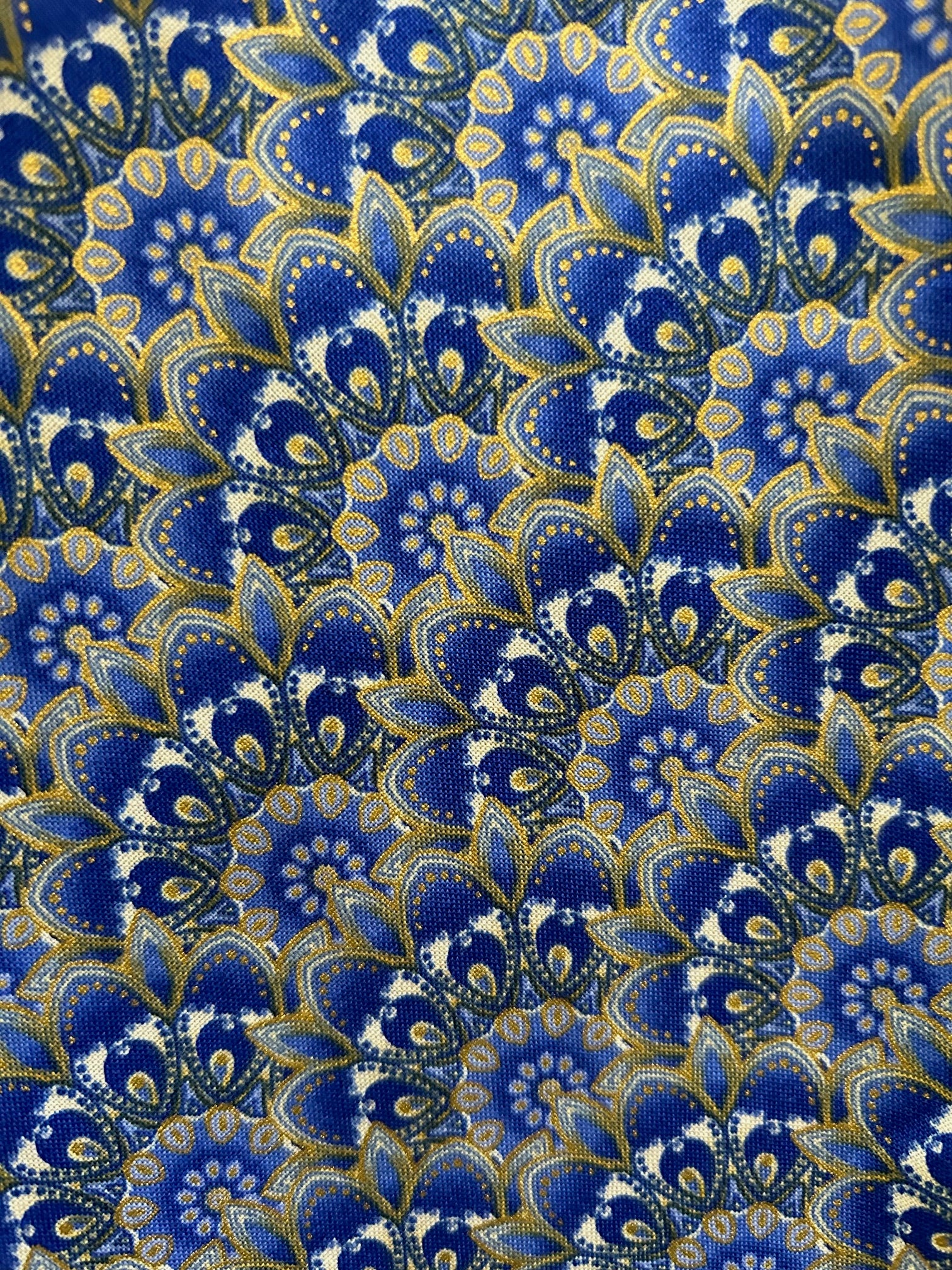 close up of the florentine print showing details of metallic gold accents and cobalt blue fan shaped design