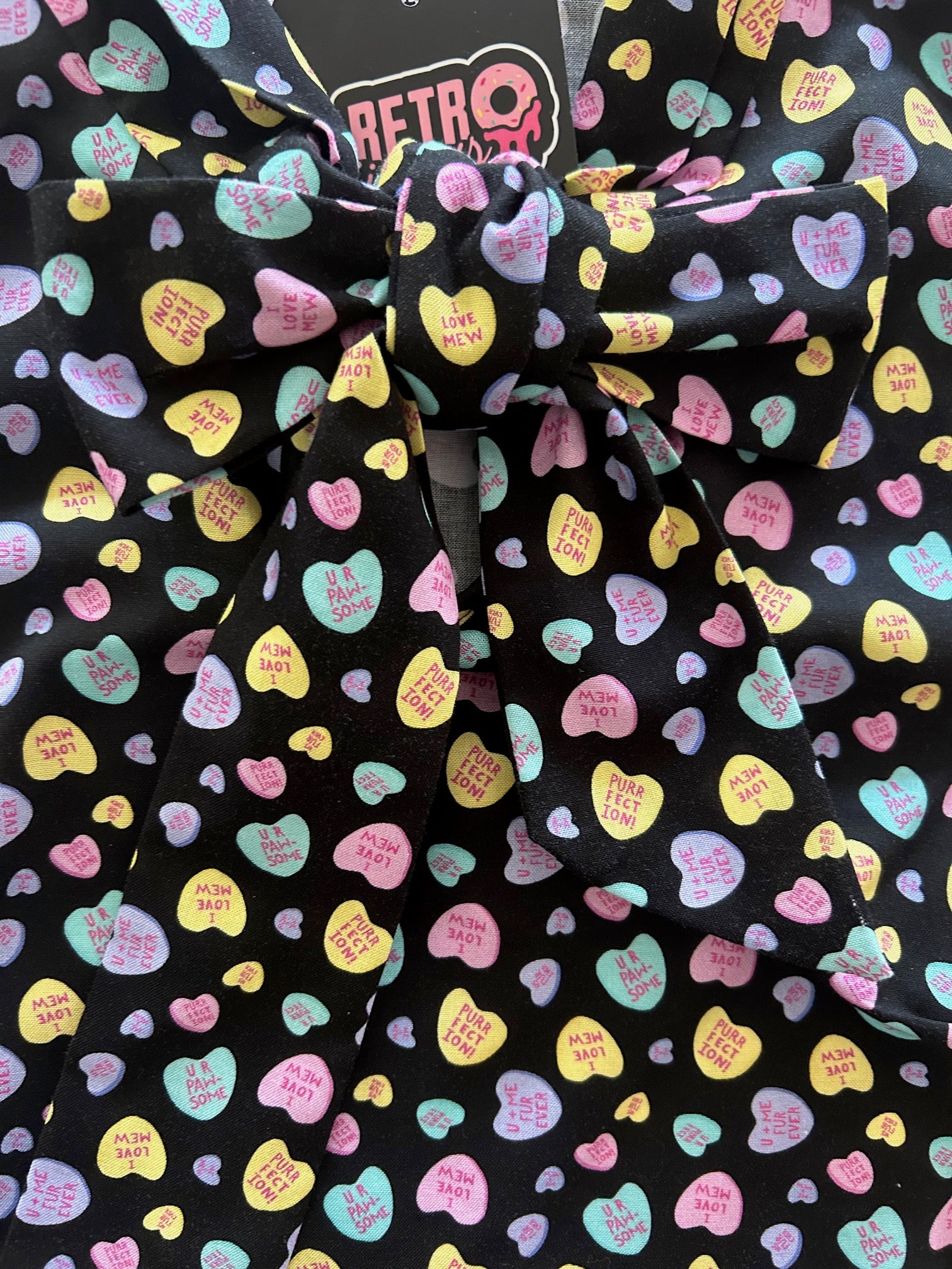 close up of conversation hearts bow top