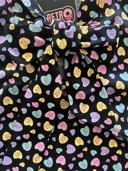 close up of conversation hearts bow top