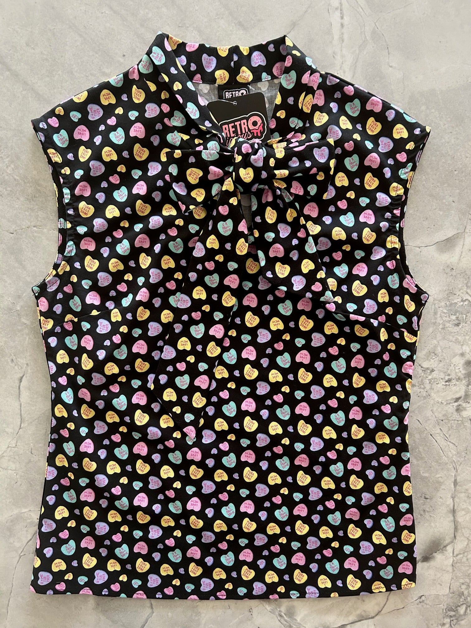 flatlay of conversation hearts bow top