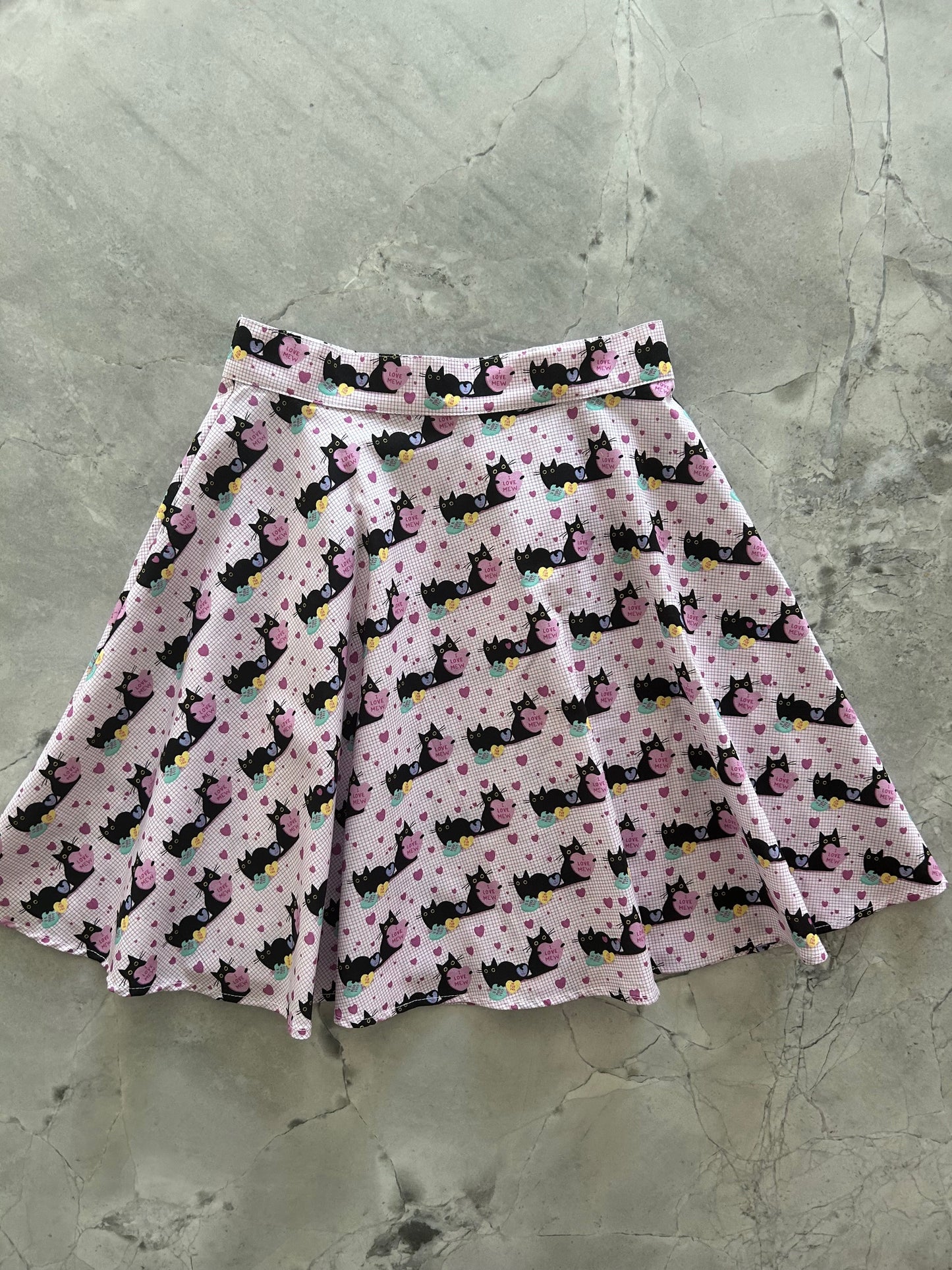 flatlay of pink cats skater skirt