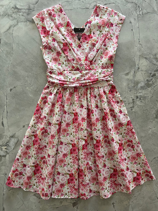 flatlay of pink roses greta dress