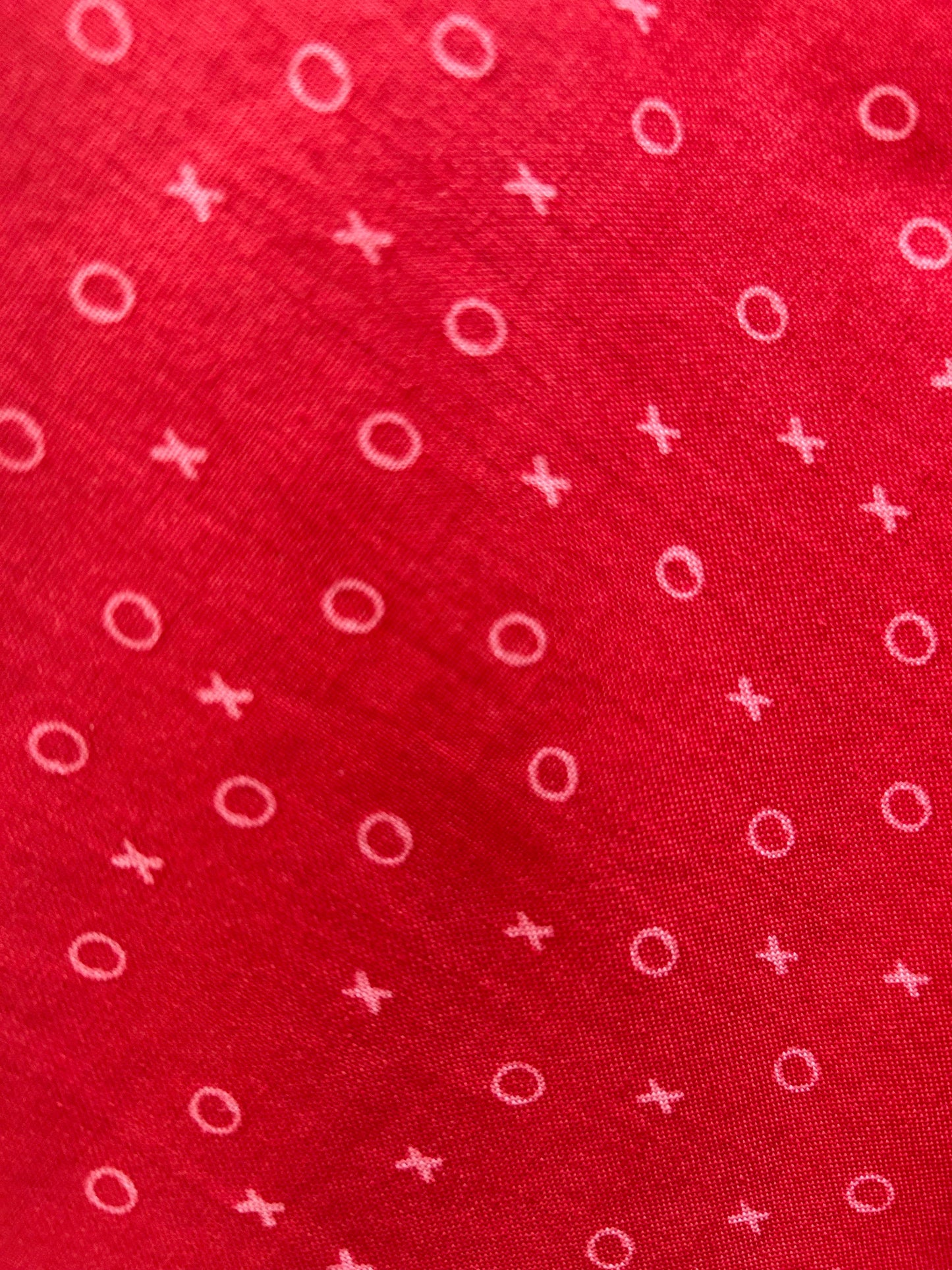 close up of xoxo skater skirt print showing the xo print on red background