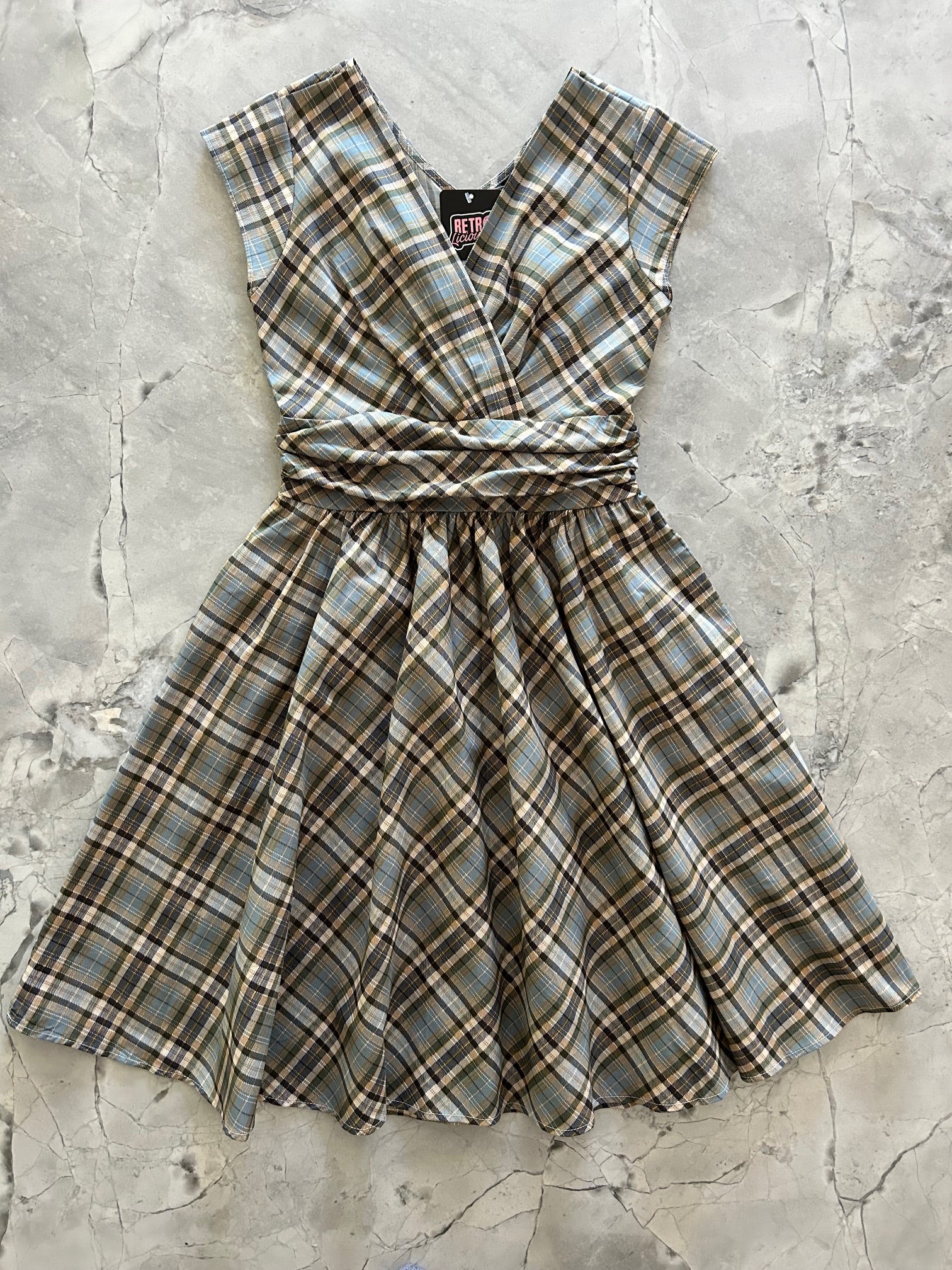 flatlay of plaid greta dress