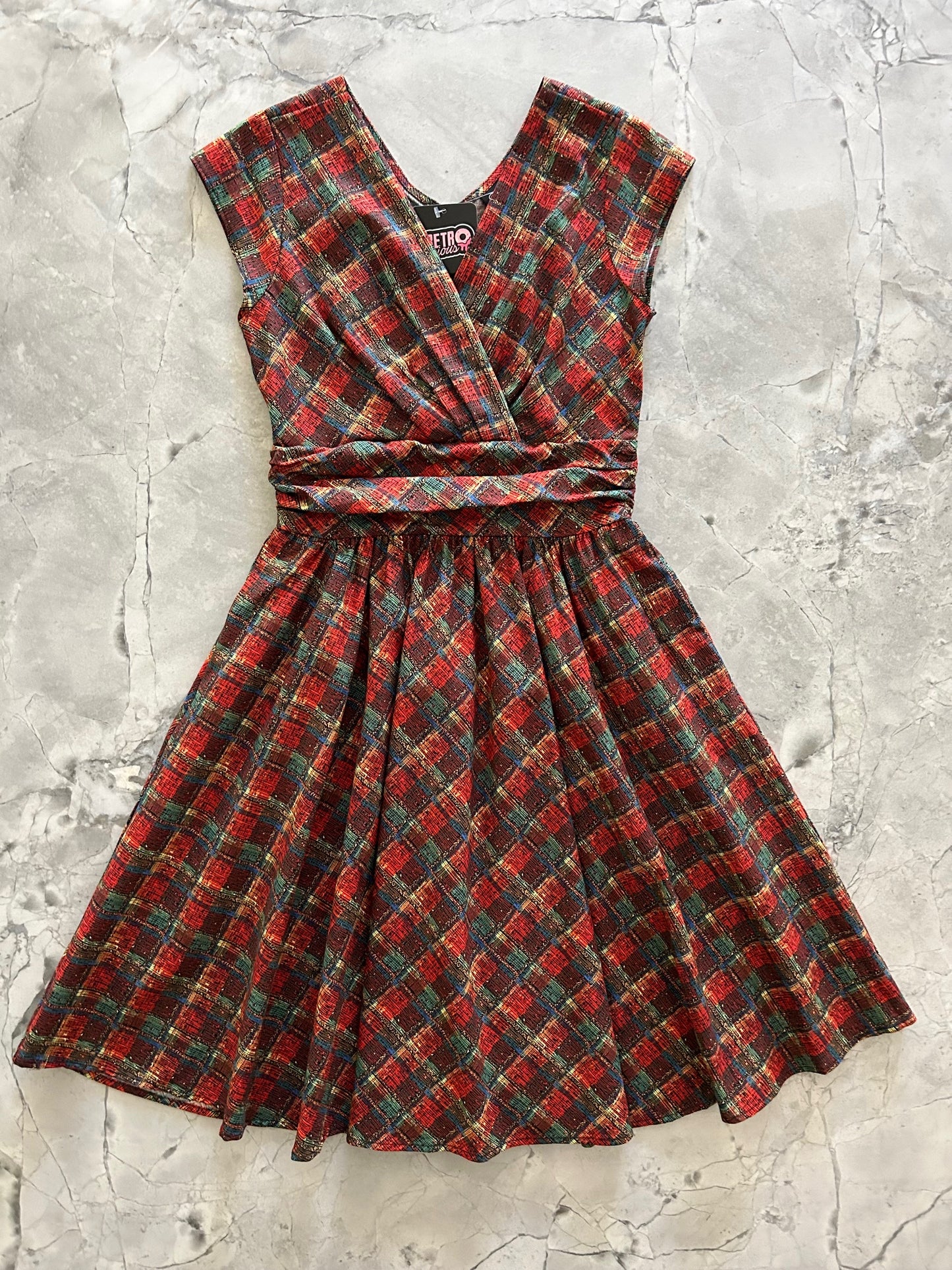 flatlay of holiday plaid greta dress