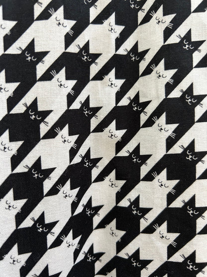 close up of print showing the black and white stacked houndstooth cats