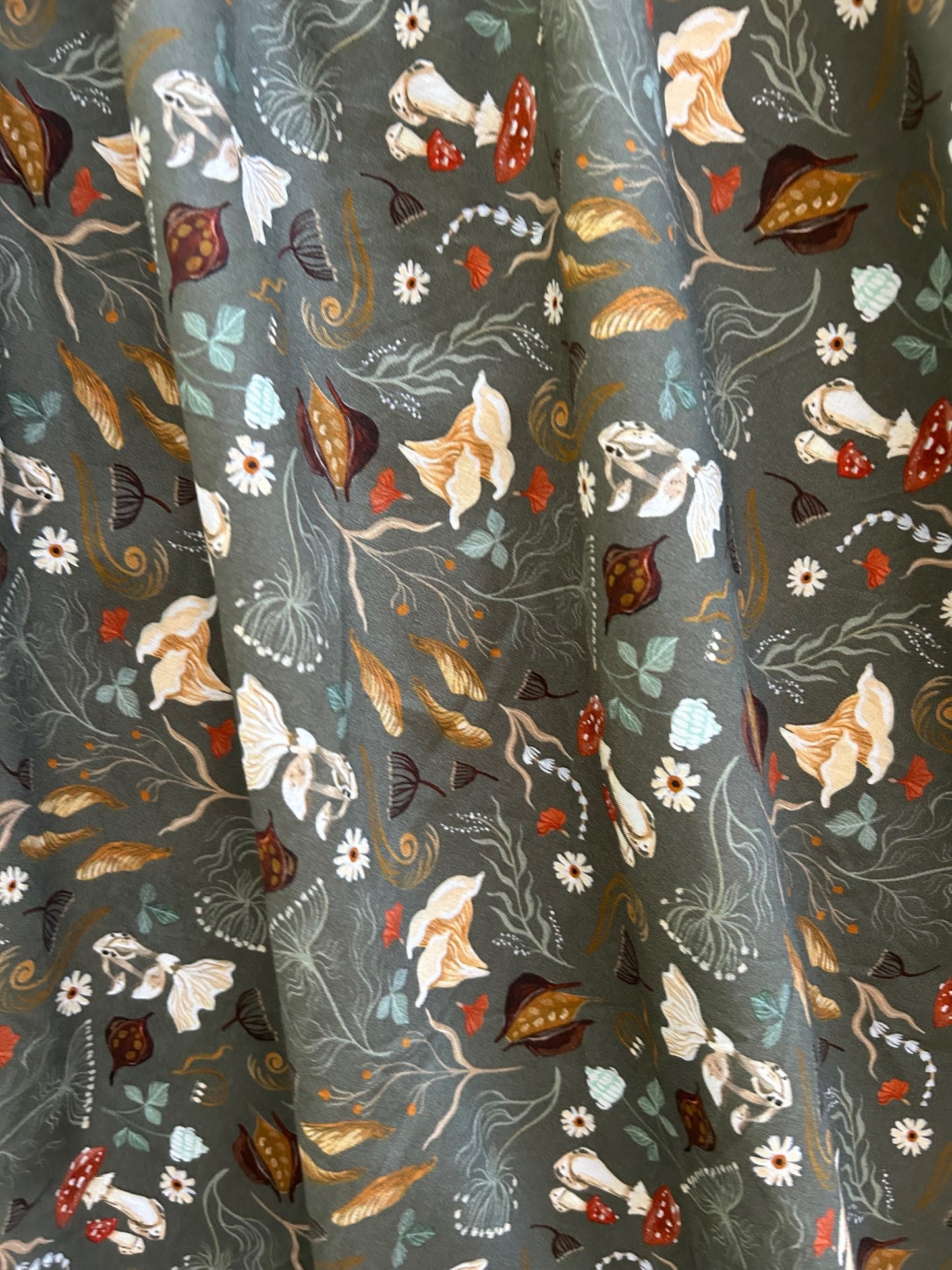 close up of fabric showing tossed mushrrom print