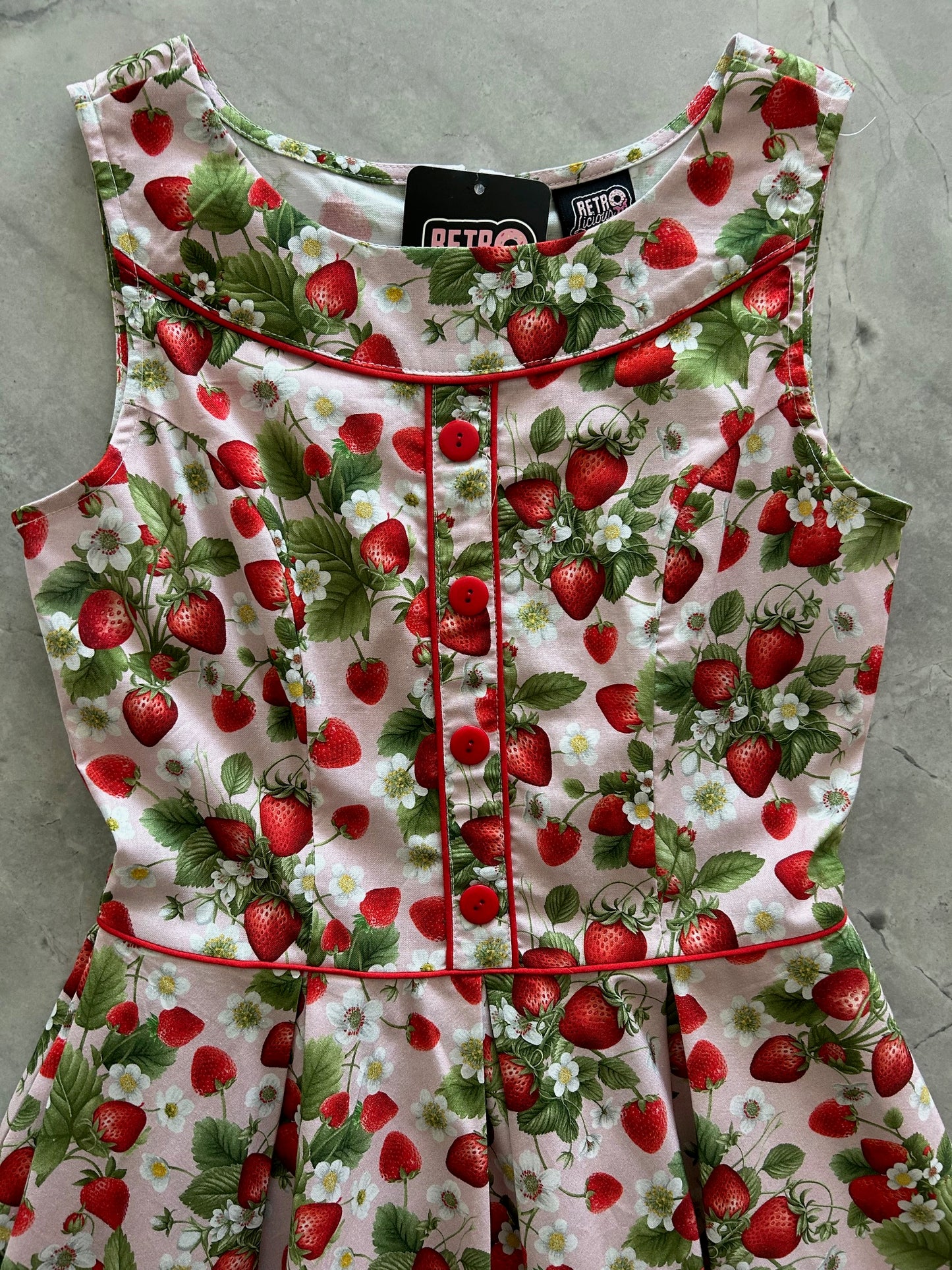 flatlay of elizabeth dress in strawberries close up