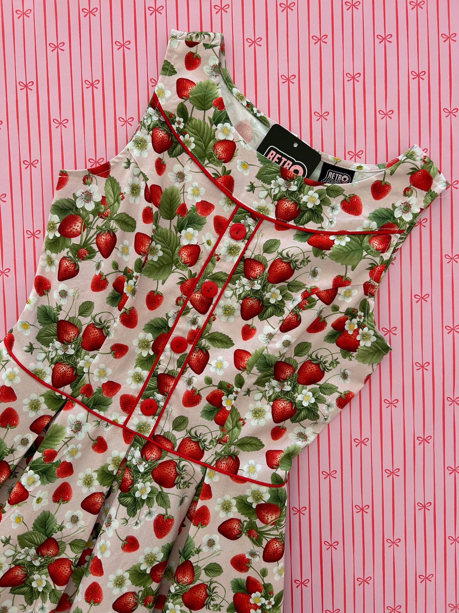 flatlay of elizabeth dress in strawberries