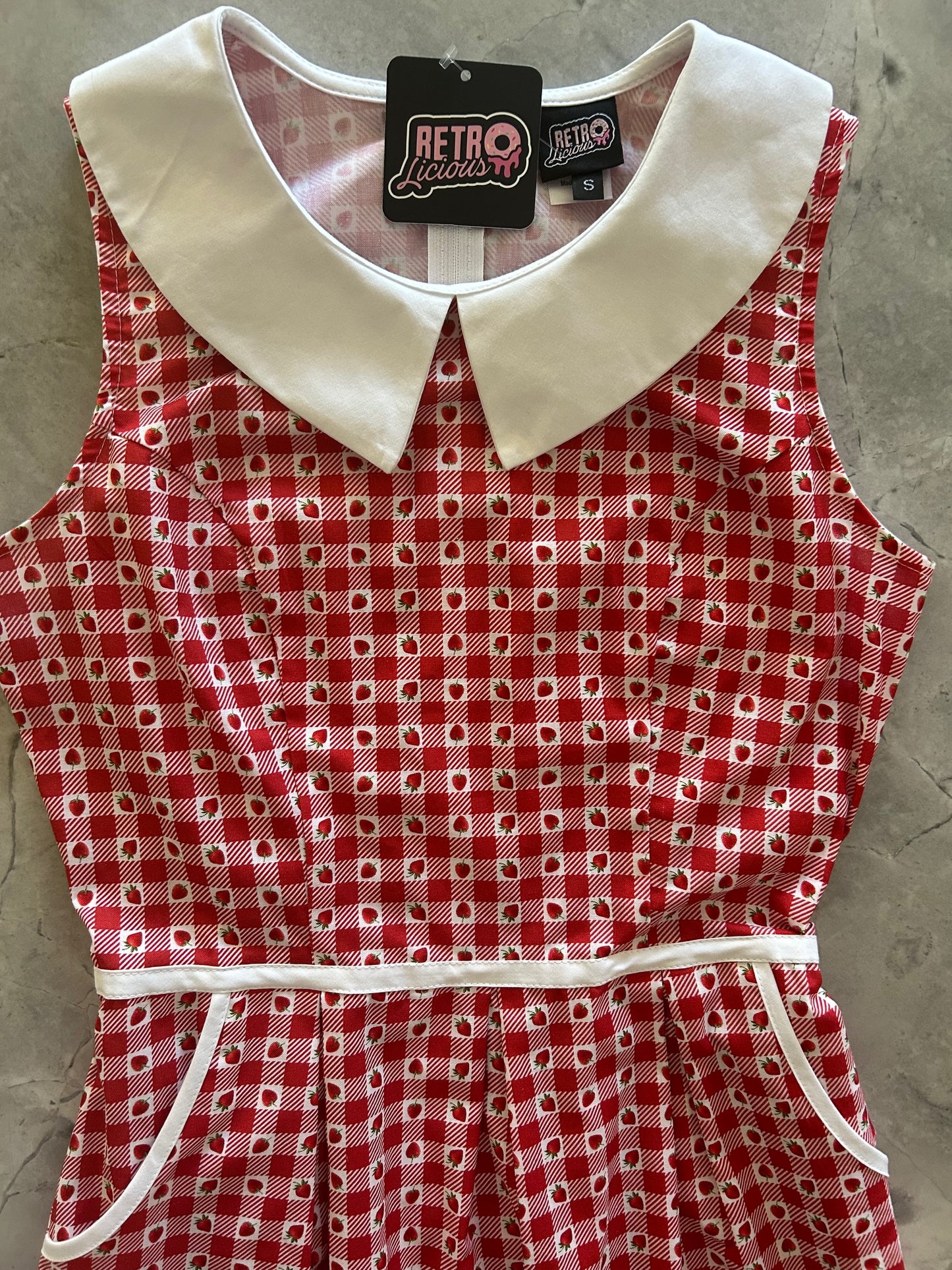 close up of bodice of strawberry gingham dress